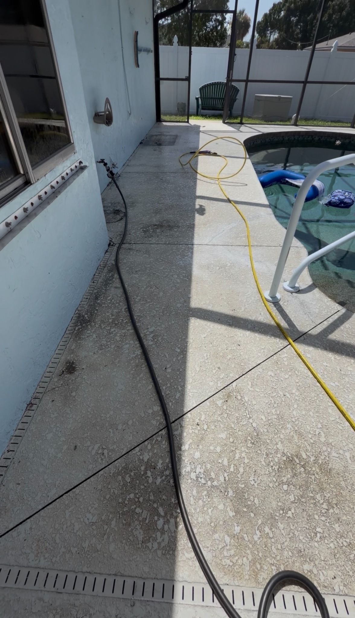Pool deck mid-cleaning, showing the split between cleaned and uncleaned concrete